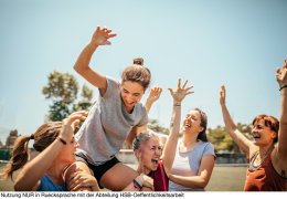 Female soccer players celebrating victory on soccer field