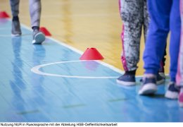 Legs in sneakers are preparing for the sports day.