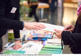 Man and Woman Sharing Information Leaflet over Exhibition Stand