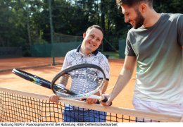 Young man with Down syndrome on tennis court