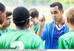 Focused soccer coach gives players a pep talk