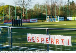 Soccer field closed due to corona virus, covid-19 pandemic. Sign with German lettering: "GESPERRT" (closed). Infection prevention in sports.