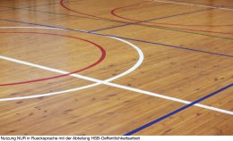 Wooden floor of sports hall with marking lines