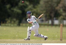 Girl playing cricket